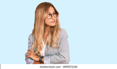 Beautiful Blonde Young Woman Wearing Business Clothes Looking To The Side With Arms Crossed Convinced And Confident 