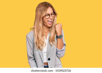 Beautiful Blonde Young Woman Wearing Business Clothes Celebrating Surprised And Amazed For Success With Arms Raised And Eyes Closed. Winner Concept. 