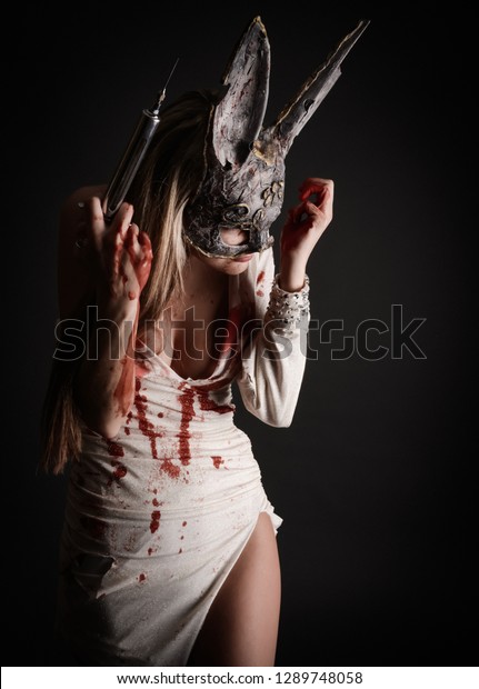 Beautiful Bloody Woman Wearing Rabbit Mask: стоковые изображения в HD и мил...