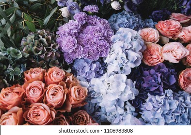 Beautiful blossoming flowers (roses, hydrangeas, carnations, eustoma) in blu, antique blue and peach colours at the florist shop - Shutterstock ID 1106983808