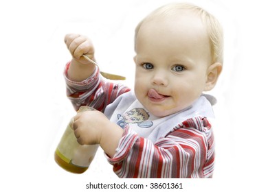 Beautiful Blue Eyed Blond Baby Eating Apple Sauce With A Spoon Isolated In White