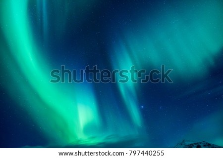 Beautiful blue and green Northern light, abstract natural background, magic paranormal light in the night starry sky, beautiful nature of Iceland
