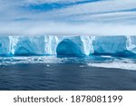 Beautiful blue iceberg and ice floe in Admiralty bay, Antarctica.