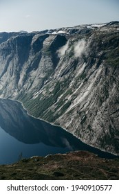 Beautiful Blue Landscape Of The Norwegian Fjord. Rocky Mountain Terrain, Deep Blue Lake, Water. Sunny Summer Day, Travel, Europe. No People, Fog. Trekking, Hiking, Unknown Wild Nature.