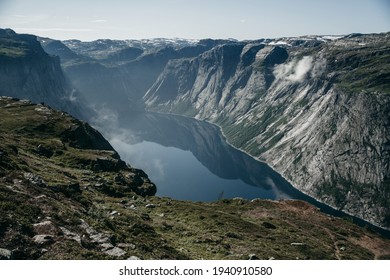 Beautiful Blue Landscape Of The Norwegian Fjord. Rocky Mountain Terrain, Deep Blue Lake, Water. Sunny Summer Day, Travel, Europe. No People, Fog. Trekking, Hiking, Unknown Wild Nature.