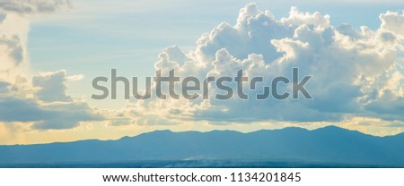 Beautiful Blue Mountain with City in Fog among green trees forest in niceday and colorful blue sky cloud.