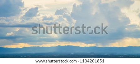 Beautiful Blue Mountain with City in Fog among green trees forest in niceday and colorful blue sky cloud.