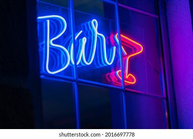 Beautiful Blue Neon Bar Sign With A Red Neon Glass On The Window. Advertising Neon Sign Glows In The Dark