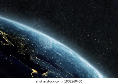 Beautiful blue planet earth with yellow city lights on the starry background in outer space