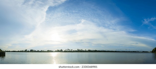 Beautiful blue sky background, white clouds covering thinly spread the sky over the river