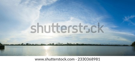 Beautiful blue sky background, white clouds covering thinly spread the sky over the river