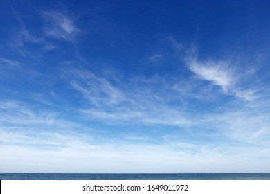 Beautiful blue sky with cirrus clouds over the sea. Skyline
