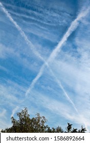 Beautiful Blue Sky With Cross X Shape And Clouds.