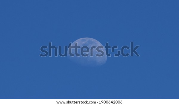 Beautiful blue sky nature with day moon, Natural\
satellite, Natural satalite, natural moon in midday, the midday\
moon, blue moon in blue day sky, super mooned blue sky cloudless\
blues sky with moons \

