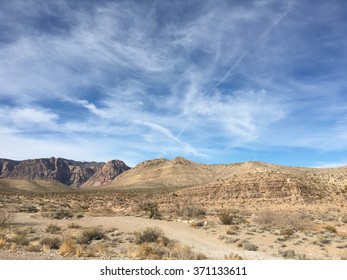 Beautiful blue sky over a dry desert dirt road  in Death Valley California 