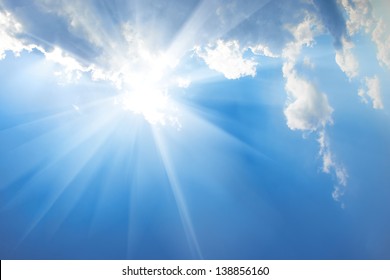 Beautiful Blue Sky With Sunbeams And Clouds. Sun Rays.