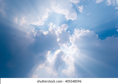 Beautiful blue sky with sunbeams and clouds. Sun rays