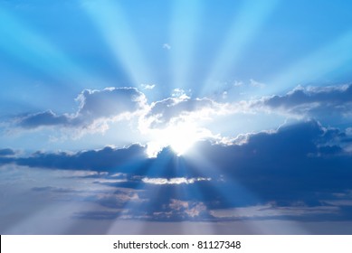 Beautiful Blue Sky With Sunbeams And Clouds. Sun Rays.