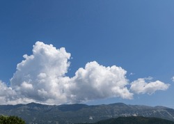 Beautiful Blue Sky With White Fluffy Clouds. Deep Blue. Mountains. Copy Space.