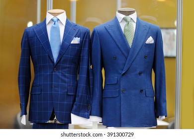 Beautiful blue suits with tie, tie clip and handkerchief on a mannequin
