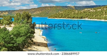 Beautiful blue turquoise verdon valley lake, green hills, sand beach - Lac de sainte croix, Verdon, France (focus on lower third)