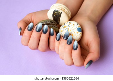 beautiful blue  blue gradient manicure  In women's hands delicious cakes purple background