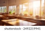 Beautiful blurred background of bright classroom and study room with panoramic windows and beautiful lighting. Blurred school classroom without students with empty chairs and tables.