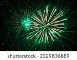 Beautiful blurred green fireworks at night.