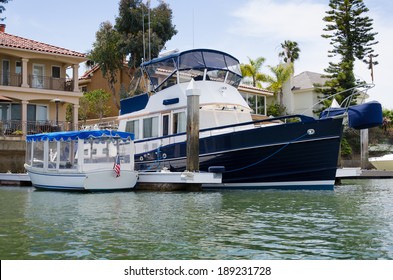 Beautiful Boat Moored Outside The Back Yard Of A Waterfront House In Newport Beach, California, USA.