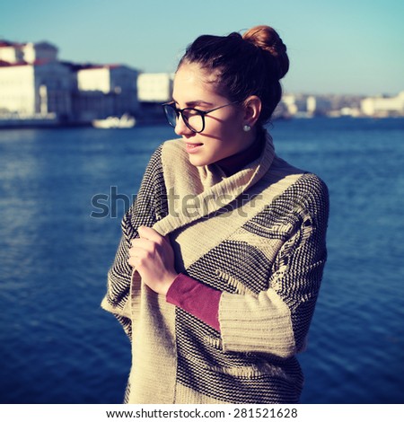Beautiful bohemian woman posing on a sea background. Boho chic style photo with a vintage retro instagram filter