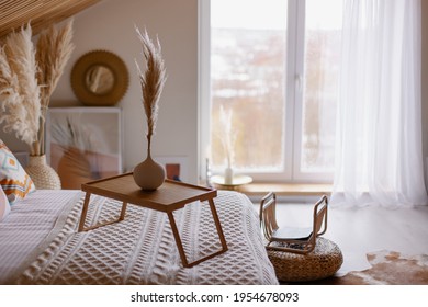 beautiful boho interior details. Pampas grass in a vase. Hygge mood. Cozy morning in the fall. Bedroom in a country house. The bed is covered with a blanket. coffee table. Relax environment - Powered by Shutterstock