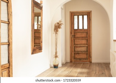 Beautiful boho interior of hallway at cozy apartment. Minimalistic Mediterranean style and design accessories. Stylish home decor.
