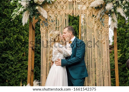 beautiful boho style wedding ceremony.
The bride in a beautiful dress and the groom in a classic suit