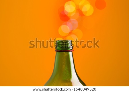 Beautiful bokeh spilling out of a glass bottleneck