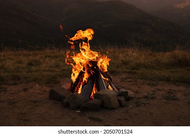 Beautiful Bonfire With Burning Firewood Outdoors At Night. Camping Season