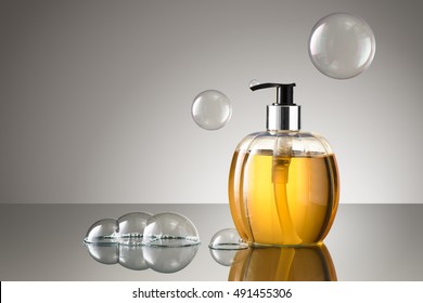 Beautiful Bottle Of Liquid Hand Soap With Bubbles On A Reflective Surface