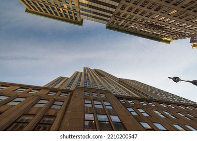 Beautiful bottom-up view on blue sky between skyscrapers. USA. New York. 