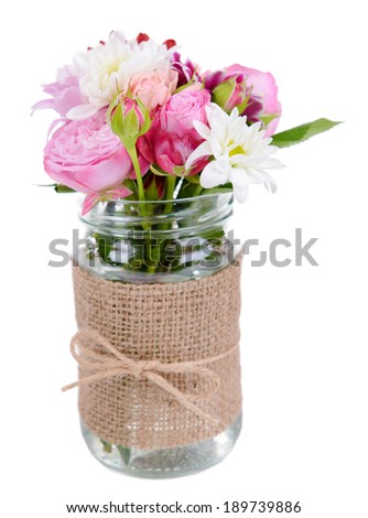 Beautiful bouquet of bright flowers in jar isolated on white