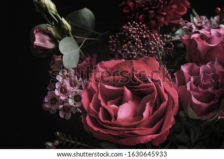 Beautiful bouquet of different flowers on black background. Floral card design with dark vintage effect