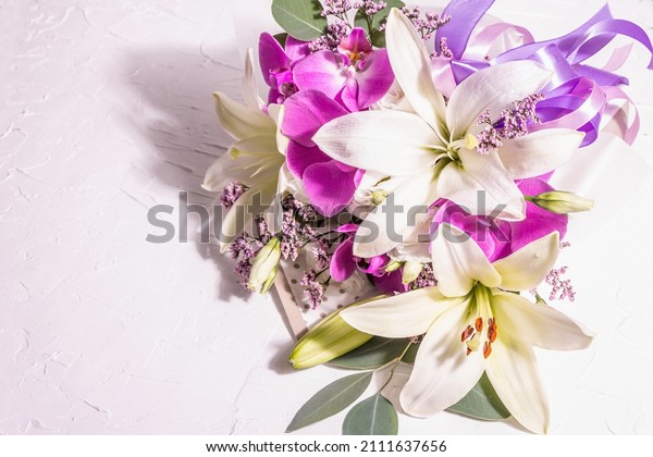 A beautiful bouquet of fresh flowers on a white\
background. The festive concept for Weddings, Birthdays, Mother\'s\
Day, For Valentine, or March 8th. Greeting card, a place for text,\
flat lay