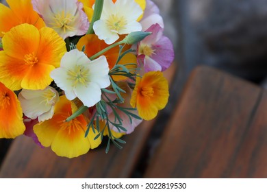 Beautiful bouquet of orange, pink and white flowers in a vase. Wild California poppy. Background photo.