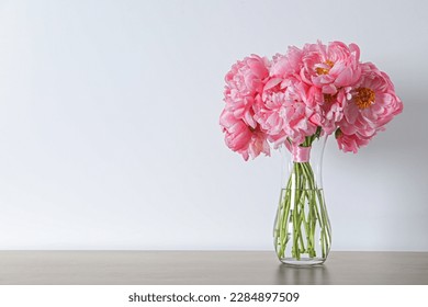 Beautiful bouquet of pink peonies in vase on table against white background. Space for text - Shutterstock ID 2284897509