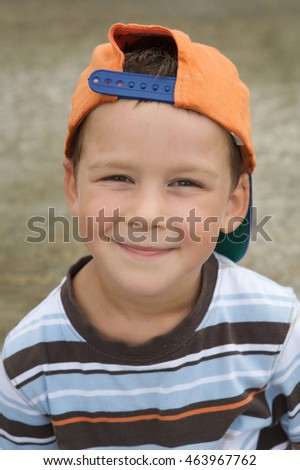 Beautiful boy with cap smiling with mischievous face
