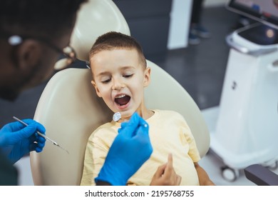 Beautiful Boy At The Dentist Getting A Check Up On Her Teeth - Pediatrics Dental Care Concepts. Cute Little Boy Getting Teeth Exam At Dental Clinic. Dental Care, Medical Care, Lifestyle