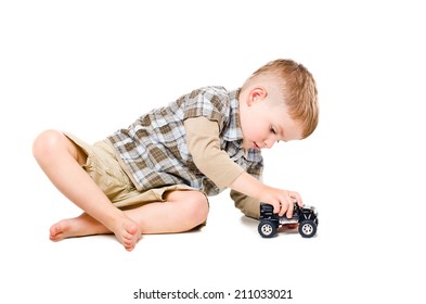 Beautiful boy playing toy car