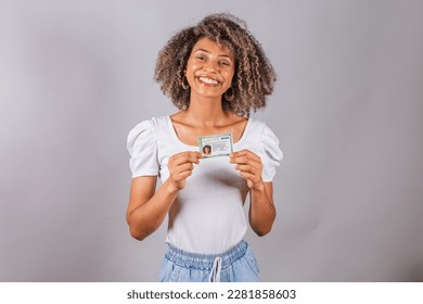 beautiful Brazilian woman, black,
holding identity card, RG.