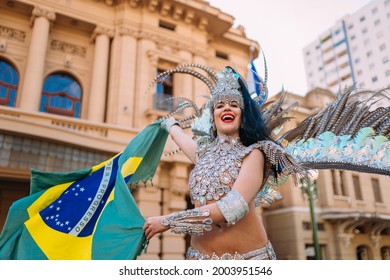 Beautiful Brazilian Woman Wearing Colorful Carnival Costume And Brazil Flag During Carnaval Street Parade In City.