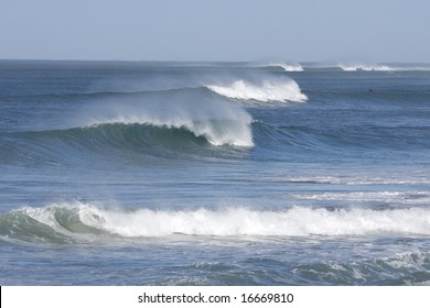 beautiful breaking waves in a row with some sea spray