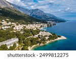 Beautiful Brela on Makarska riviera, Croatia. Adriatic Sea with amazing turquoise clean water and white sand. Aerial view of Brela town and waterfront on Makarska riviera, Dalmatia region of Croatia.