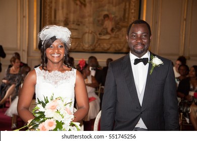 Beautiful Bride and groom African American smiling at the camera in city hall during wedding celebration